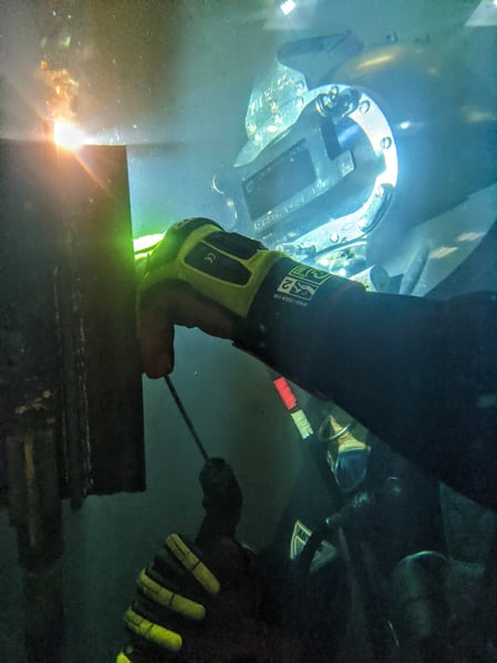 Kendal performing an underwater weld