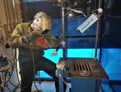 Student performing a weld with a Xiris weld camera recording their weld