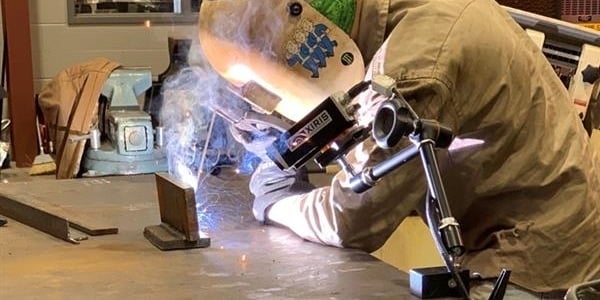 Student performing a weld with a Xiris Weld Camera capturing recorded video